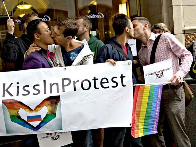 Protesters of Russia's recently passed anti-gay laws kiss outside the Russian Consulate in Vancouver. (Reuters Photo)