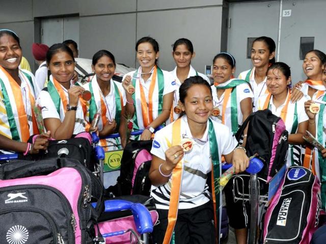 Players of Indian Women's Junior Hockey team, that won the bronze medal at Junior Hockey World Cup, show their bronze medals after their arrival at the Indira Gandhi International Airport in New Delhi. (Sushil Kumar/HT Photo)
