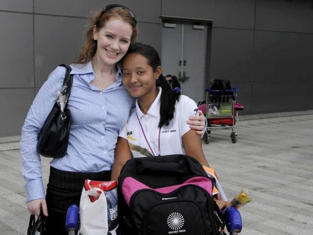 CEO of Indian Women's Junior Hockey team Elena Norman and captain Sushila Chanu show their bronze medals after arriving at the Indira Gandhi International Airport in New Delhi. (Sushil Kumar/HT Photo)