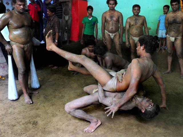 Wrestlers perform at the historic Loknath Vyayamsala on the occasion of Nag Panchami in Allahabad. (AFP Photo)