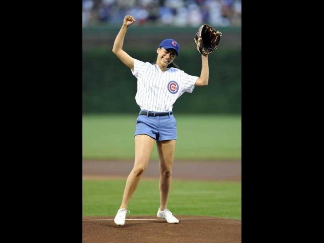 Actress Aimee Garcia reacts after throwing out the first pitch before the Cincinnati Reds and Chicago Cubs baseball game in Chicago. (AP Photo)