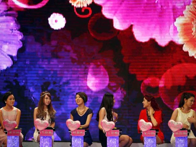 Women talk during the recording of an episode of a matchmaking television programme, "One out of 100", in Shanghai. (Reuters Photo)