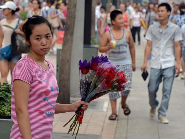 A young girl holds roses during the Qixi festival which is also known as the 'Chinese Valentine's Day' in Beijing. AFP