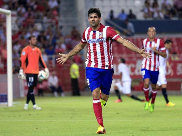 Atletico Madrid's Diego Costa celebrates after scoring against Sevilla during their Spanish First Division soccer match at Ramon Sanchez Pizjuan stadium in Seville. (Reuters Photo)