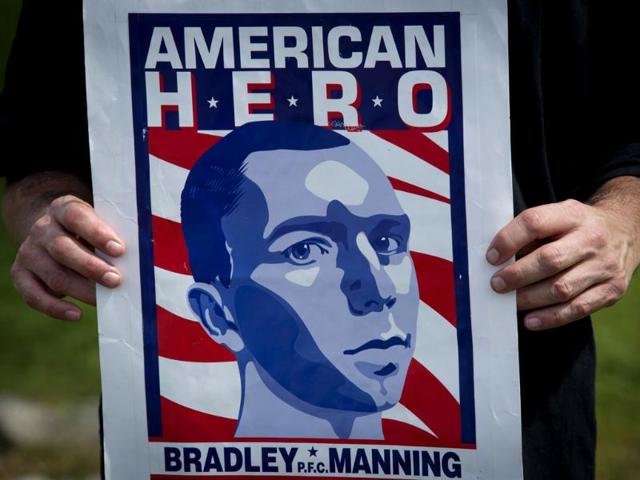 A supporter of Bradley Manning holds a poster after attending his sentencing hearing at a US military court facility at Fort Meade, Maryland. (AFP Photo)
