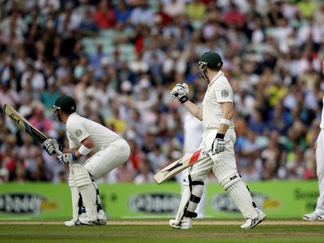 Australia's Steven Smith (C) reacts after hitting a six off England's Jonathan Trott (R) to reach his century, with teammate Brad Haddin (L) on the fifth Ashes Test The Oval. (AP Photo)