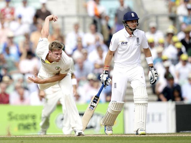 England's Joe Root looks on as Australia's James Faulkner bowls to England's Jonathan Trott during play on the third day of the fifth Ashes Test at The Oval in London. (AP Photo)