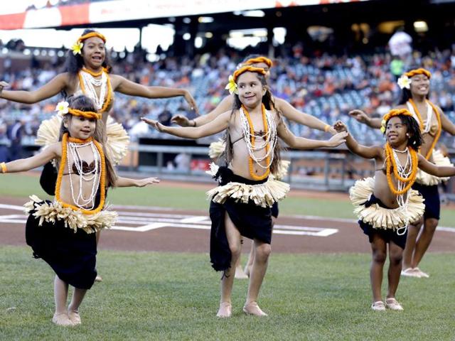 A group of dancers with the group Ehulani Otea perform during a tribute to Polynesian Heritage Night before the start of a baseball game between the San Francisco Giants and the Pittsburgh Pirates in San Francisco. AP photo