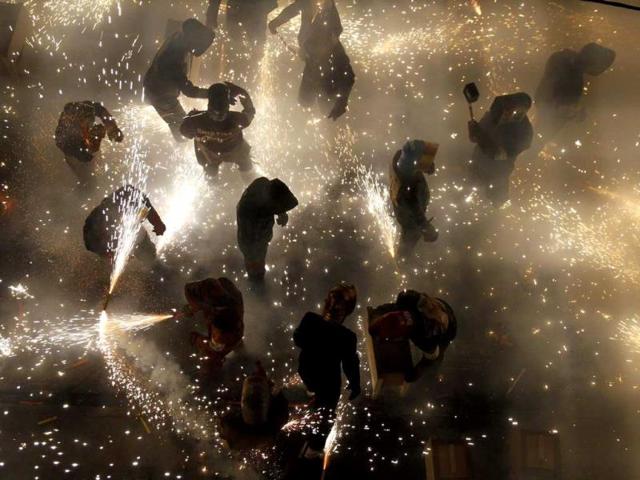 Revellers play with fireworks in an enclosed area on the main street of the village of Paterna near Valencia during the annual "Corda" festivity. (Reuters Photo)