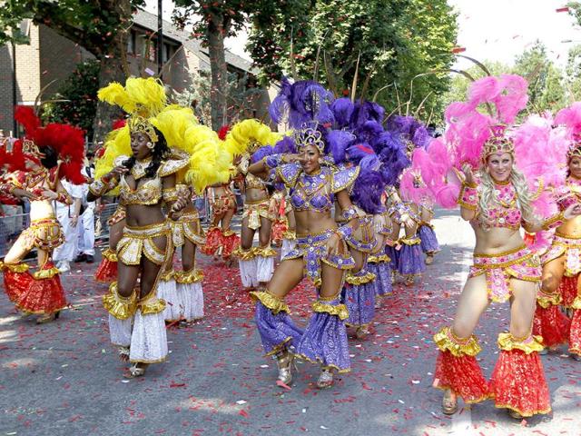 Revellers dance as they parade through the streets during the Notting Hill Carnival in London. (AP Photo)