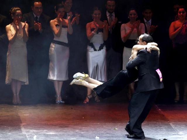 Maximiliano Cristiani (R) and Jesica Arfenoni from Argentina embrace as they react after winning the Tango World Championship in Salon style in Buenos Aires. (Reuters Photo)