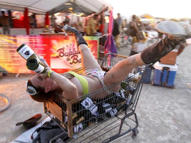 A participant poses next to an art installation at the 2013 Burning Man arts and music festival in the Black Rock desert of Nevada. (Reuters Photo)
