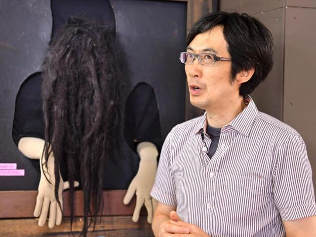 The creator of "The Cursed Tooth", Hirofumi Gomi, at one of the haunted houses he created around Japan. (AFP Photo)