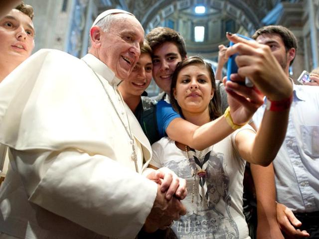 Pope Francis has his picture taken inside St Peter's Basilica with youths from the Italian Diocese of Piacenza and Bobbio, who came to Rome for a pilgrimage, at the Vatican (AP Photo)