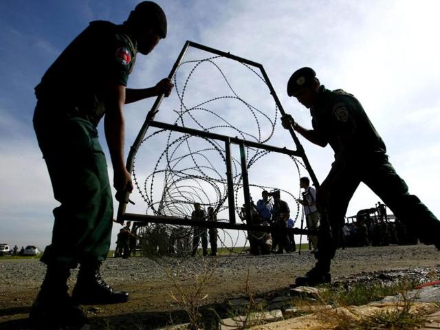 Cambodian police officers move barbed wire during a security drill in Phnom Penh, Cambodia. (AP Photo)