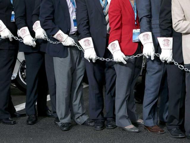 Local officials wear protective gloves during a chain-cutting ceremony to officially open the San Francisco Oakland Bay Bridge. AFP