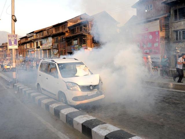 Police throw tear gas towards protesters during a protest against the Ehaas-e-Kashmir music concert in Srinagar. (AFP Photo)