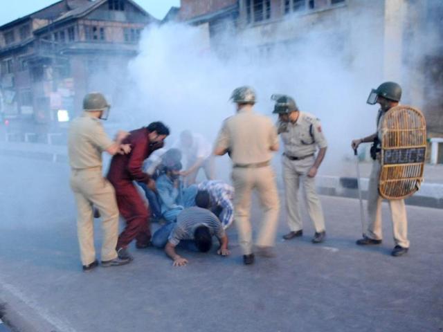 Police throw tear gas canister towards Chairman of Jammu and Kashmir Liberation front Yasin Malik and supporters during a protest in Srinagar. (AFP Photo)