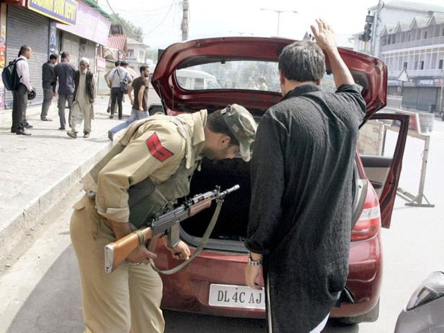 A security person checking a vehicle during high alert in the view of classical music maestro Zubin Mehta's Concert, at Lal Chowk in Srinagar. (PTI Photo)