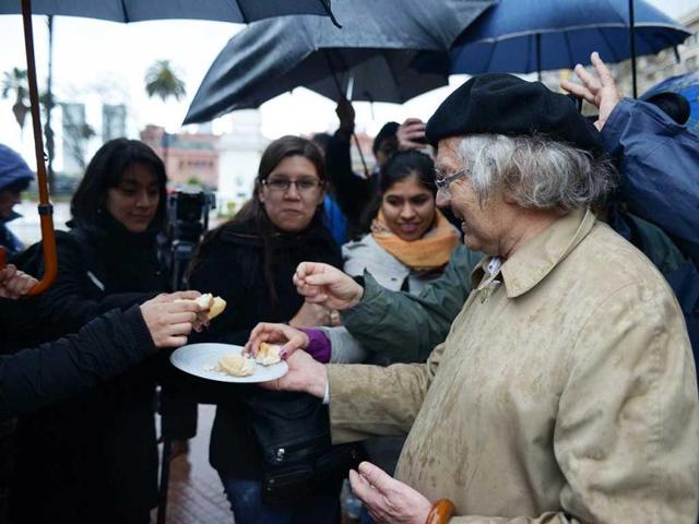 1980 Nobel Peace Prize Adolfo Perez Esquivel shares bread during an ecumenical ceremony in which representatives of several religions join him to call for peace in Syria at Mayo square in Buenos Aires. AFP photo