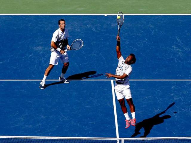 Leander Paes smashes the ball next to his partner Radek Stepanek during their US Open men's doubles final against Alexander Peya and Bruno Soares. (AFP Photo) 