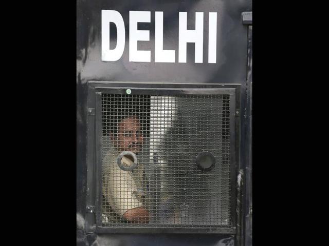A policeman looks out from the van carrying four men convicted in December 16 Delhi gang-rape case. (AP Photo)