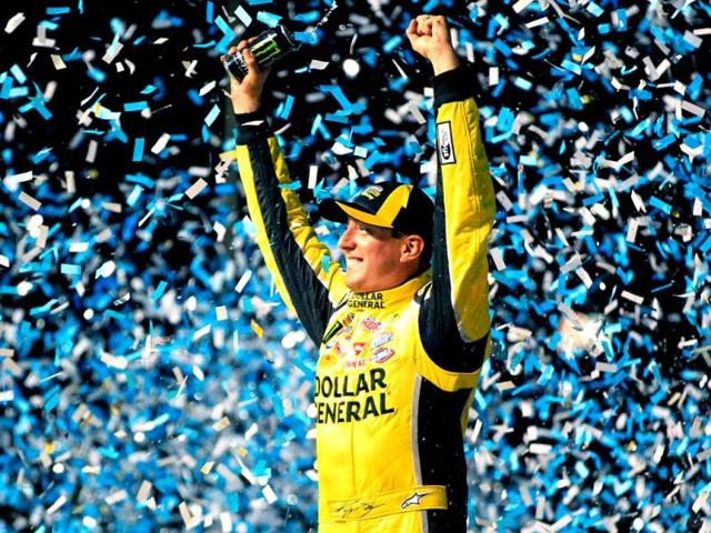 Kyle Busch, driver of the #51 Dollar General Toyota, celebrates in Victory Lane after winning the NASCAR Camping World Truck Series enjoyillinois.com 225 at Chicagoland Speedway in Joliet, Illinois. (AFP Photo)