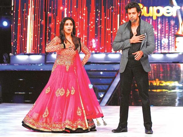 Dancing diva Madhuri Dixit's moves seem to have tired Hrithik Roshan. Or is it the Bollywood queen's charisma that made him sigh? (Photos: Prodip Guha)