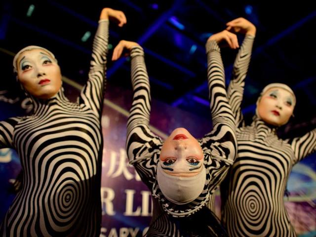 Performers from the circus act Cirque du Soleil poses for photos at a gala event in China. (AFP Photo)