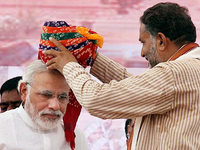 BJP's prime ministerial candidate for the 2014 elections and Gujarat CM Narendra Modi being welcomed at his rally in Rewari, Haryana. (PTI Photo)