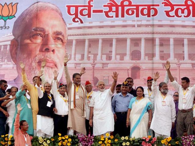 BJP's PM candidate for the 2014 elections and Gujarat chief minister Narendra Modi with party workers during his rally in Rewari, Haryana. (PTI Photo)