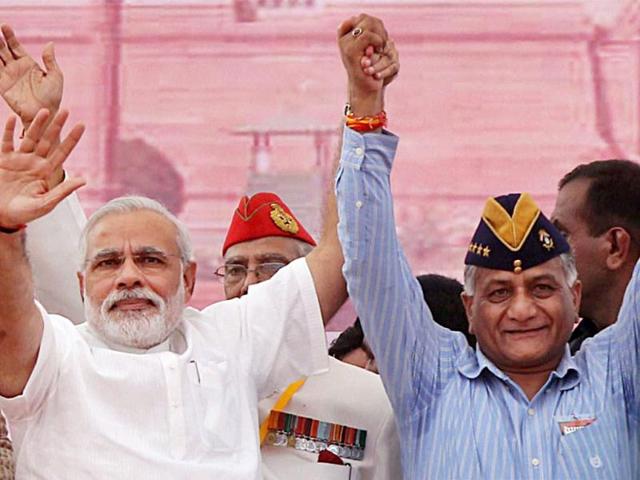 BJP's PM candidate for the 2014 elections and Gujarat chief minister Narendra Modi with retired Army chief VK Singh during Modi's rally in Rewari, Haryana. (PTI Photo)