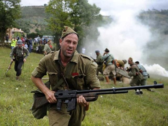 An actors takes part in a re-enactment of the "Battle of Areces" that took place during the Spanish Civil War, in Grullos, north of Spain, September 14, 2013. The re-enactment of the historic 1937 battle was organised by the Frente del Nalon Association. REUTERS