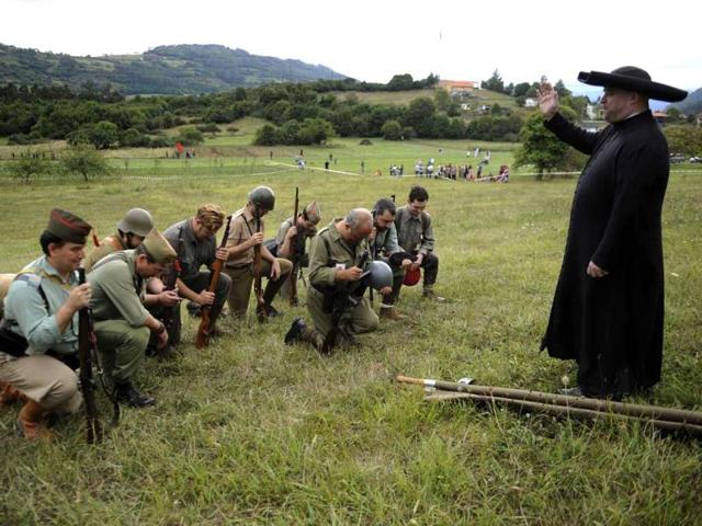 An actors takes part in a re-enactment of the "Battle of Areces" that took place during the Spanish Civil War, in Grullos, north of Spain, September 14, 2013. The re-enactment of the historic 1937 battle was organised by the Frente del Nalon Association. REUTERS