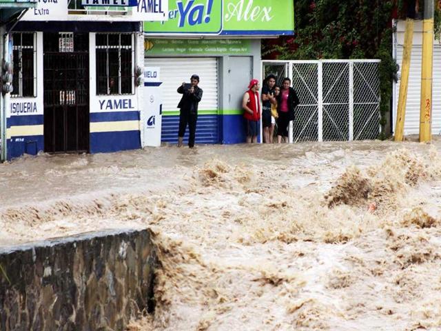 Residents stand in flooded streets in Chilpancingo, Guerrero state, Mexico following tropical storm Manuel. (AFP Photo)