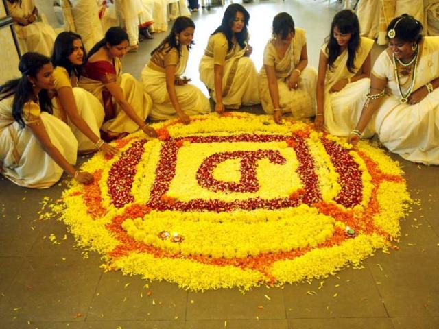 Ladies prepare floral rangoli on the occassion on Oman at Raghuleela Mall in Vashi, Navi Mumbai. (PTI photo)