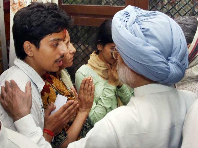 Prime Minister Manmohan Singh consoling the family members of a journalist who was killed in the riots, in Muzaffarnagar district on Monday. (PTI Photo)