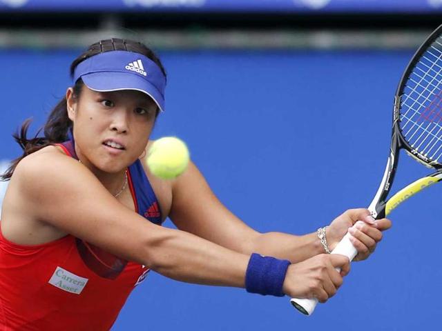 Ayumi Morita of Japan returns the ball against Britain's Laura Robson during their first round match of Pan Pacific Open tennis tournament in Tokyo. (AP Photo)
