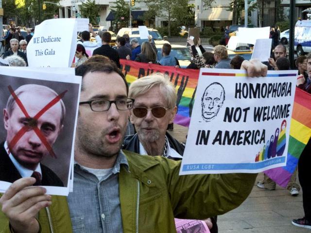 An anti-Putin protestor demonstrates in front of the Metropolitan Opera at Lincoln Center in New York. Putin who has upheld anti-gay laws passed by the Russian legislature.(AP photo)