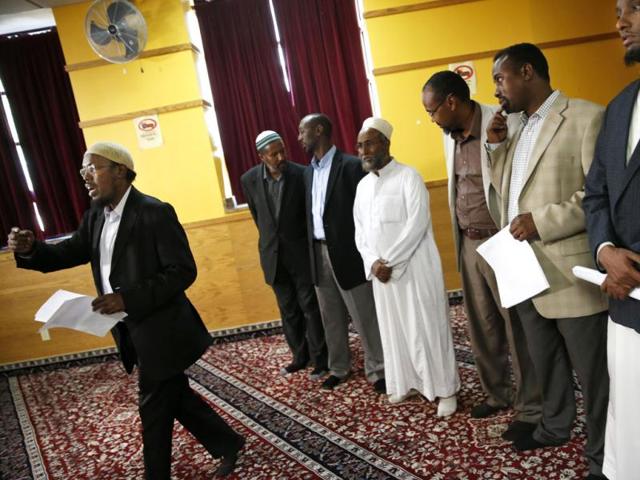 Local imams and Muslims, including the AIC's Abdul Aziz (left) and Imam Abdirizak Hashi, stand in solidarity to speak out against extremism in the Nairobi shopping mall attack in Minneapolis. (AP Photo)