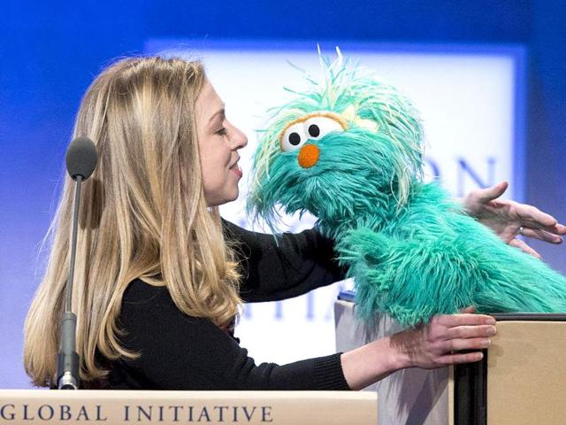 Chelsea Clinton, daughter of former US President Bill Clinton, interacts with Rosita the muppet at the Clinton Global Initiative in New York. (Reuters Photo)
