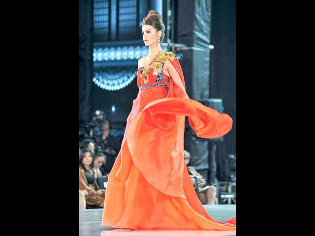 Miss Cyprus, Kristy Marie Agapioy walks on the catwalk during the fashion show of Miss World contestants at a convention center in Nusa Dua, in Indonesia's resort island of Bali. AFP photo