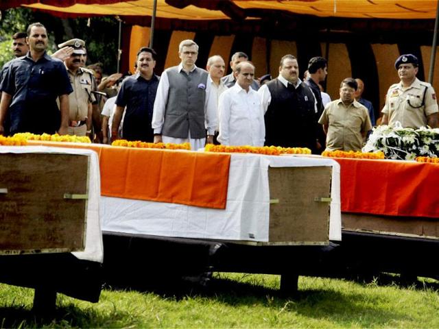 Jammu and Kashmir CM Omar Abdullah along with minister paying tributes in Jammu to the policemen who were killed in militants' attacks in Kathua and Samba. (PTI Photo)