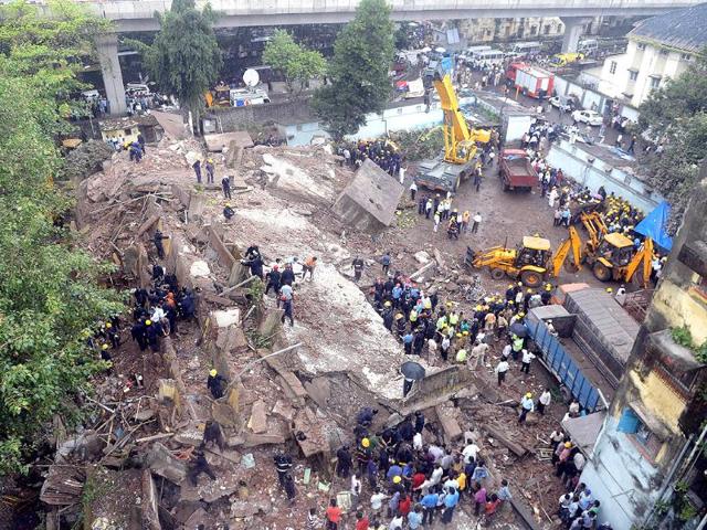 An aerial view of firefighters and rescue workers working at the site of the building collapse in Mumbai. (AFP Photo)