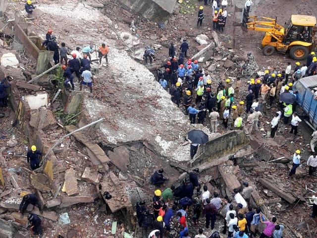 Yet another building has collapsed in Mumbai. Here, firefighters and rescue workers are seen working at the site of the building collapse. (AFP Photo)