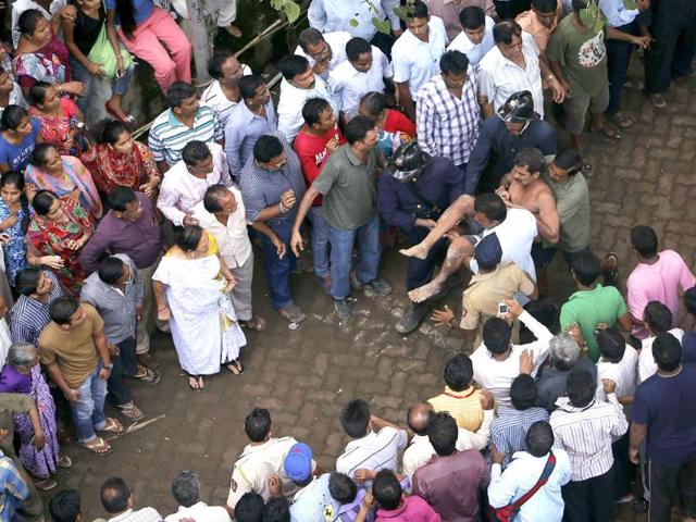 Rescue workers carry a man who was rescued from the rubble at the site of a collapsed residential building in Mumbai. (Reuters Photo)