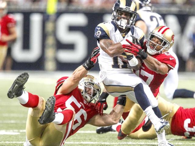 St Louis Rams wide receiver Tavon Austin (C) tackled by San Francisco 49ers linebacker Nathan Stupar (L) and defensive back CJ Spillman during the second half of their NFL football game in St. Louis, Missouri. (Reuters Photo)