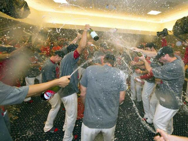 The St Louis Cardinals celebrate after their game against the Chicago Cubs at Busch Stadium. The Cardinals defeated the Cubs 7-0 to win the National League Central Title. (Scott Rovak/AP Photo)