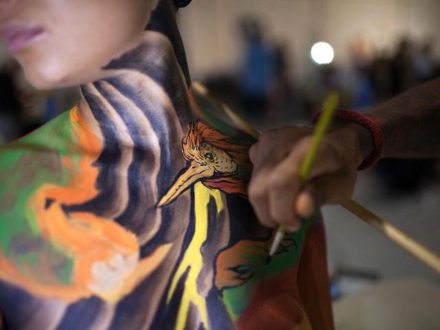 An Atlanta artist paints on a model at the contest. 40 artists from nine countries are competing in the first such competition. (AP Photo)