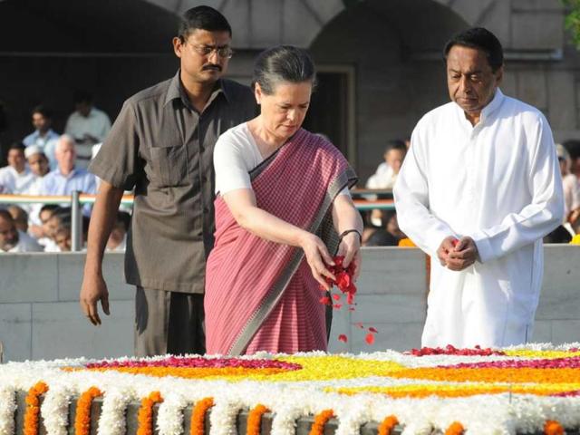 Congress chairperson Sonia Gandhi (C) pays her respects at the memorial to the Father of the Nation Mahatma Gandhi at Rajghat in New Delhi on his 144th birth anniversary. (AFP Photo)
